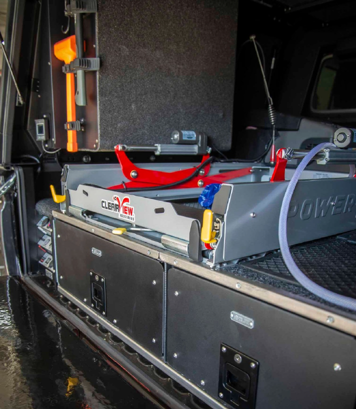 Interior of a service truck showing a mounted ClearVIEW equipment tray with clamps, hoses, and a yellow handle.